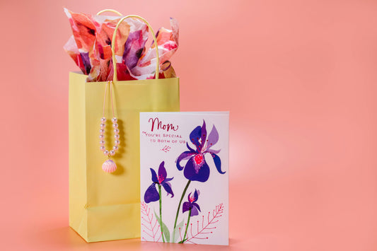Mother’s Day gift with flowers, a card, and a wrapped present on a table