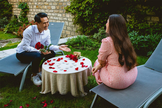 Man and woman have a conversation at a table.